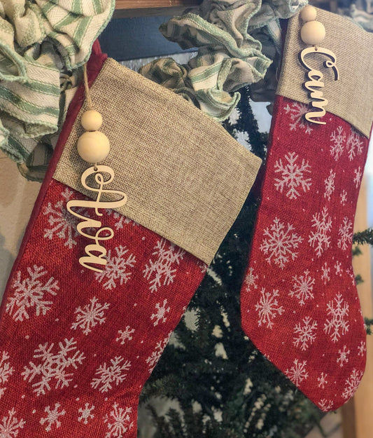 Two stockings hanging both with name stocking tags hanging in front
