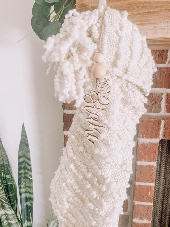 Stocking hanging with name tag hanging in front of it